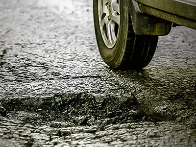 How to safely drive through potholes to preserve your vehicle's undercarriage